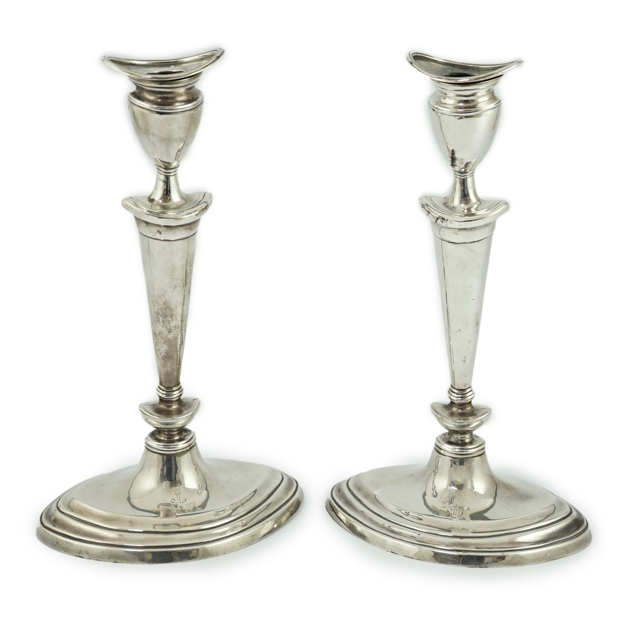 A pair of late Victorian silver oval candlesticks by Goldsmiths & Silversmiths (Gibson & Langman)